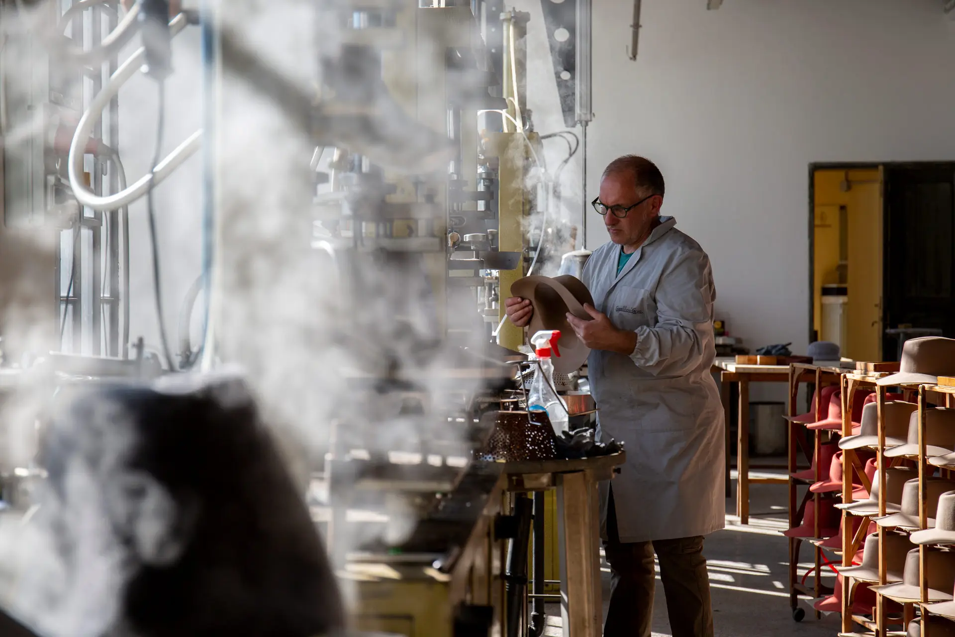 A craftsman shapes felt with steam